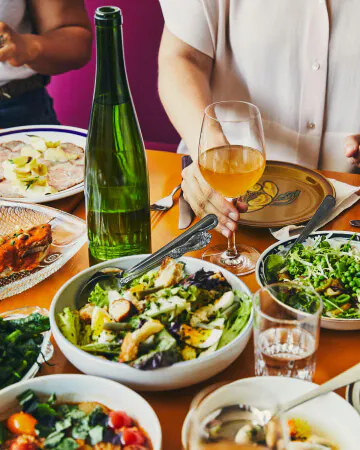 Multiple dishes served with wine