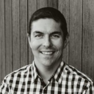 A photograph of Ryan Ruhl smiling, looking into the camera