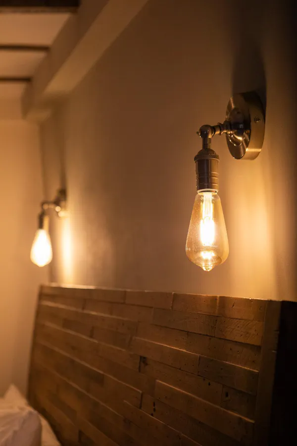 wall, light fixture, ceiling, lighting, incandescent light bulb, brown