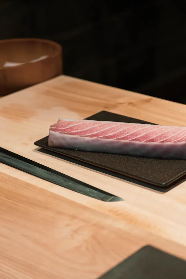 food, cutting board, fish slice, sashimi, meat, kitchen utensil