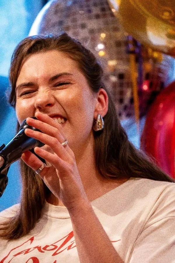 nose, microphone, lip, chin, hairstyle, gesture