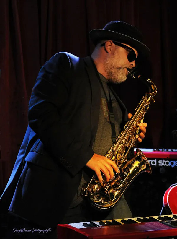 musical instrument, saxophone, saxophonist, hat, reed instrument, brass instrument
