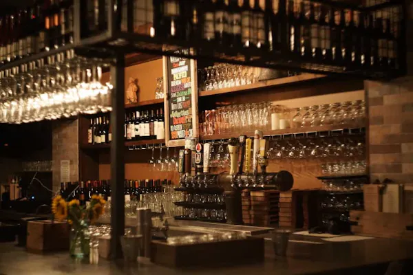 drinking establishment, drinkware, bottle, barware, shelf, building