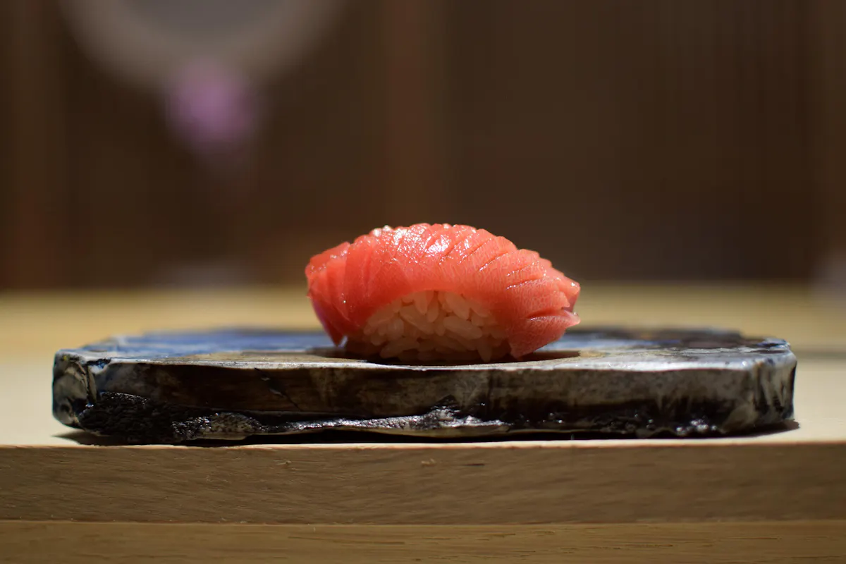 KYŌTEN Chicago tuna nigiri on ceramic plate at the omakase counter