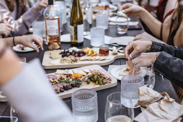 food, tableware, hand, table, bottle, plate