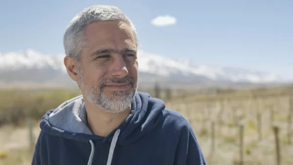 sleeve, happiness, mountainous landforms, smile, facial expression, facial hair