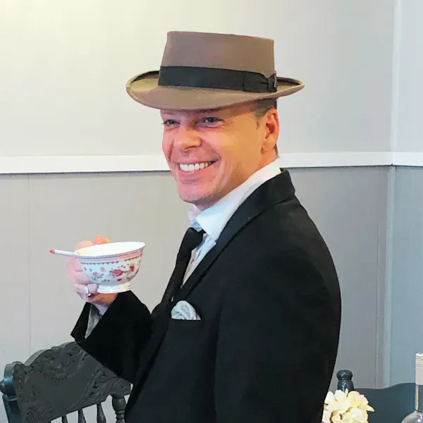 hat, headgear, facial expression, smile, collar, formal wear
