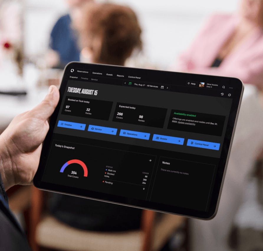 concierge selecting tables on the Tock Dashboard app with a tablet device