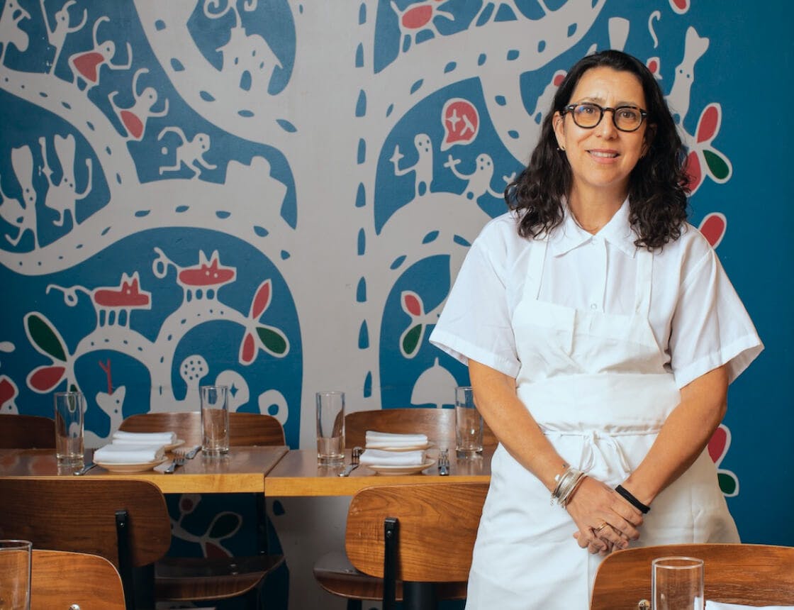 Chef portrait in an apron with arms crossed looking at the camera