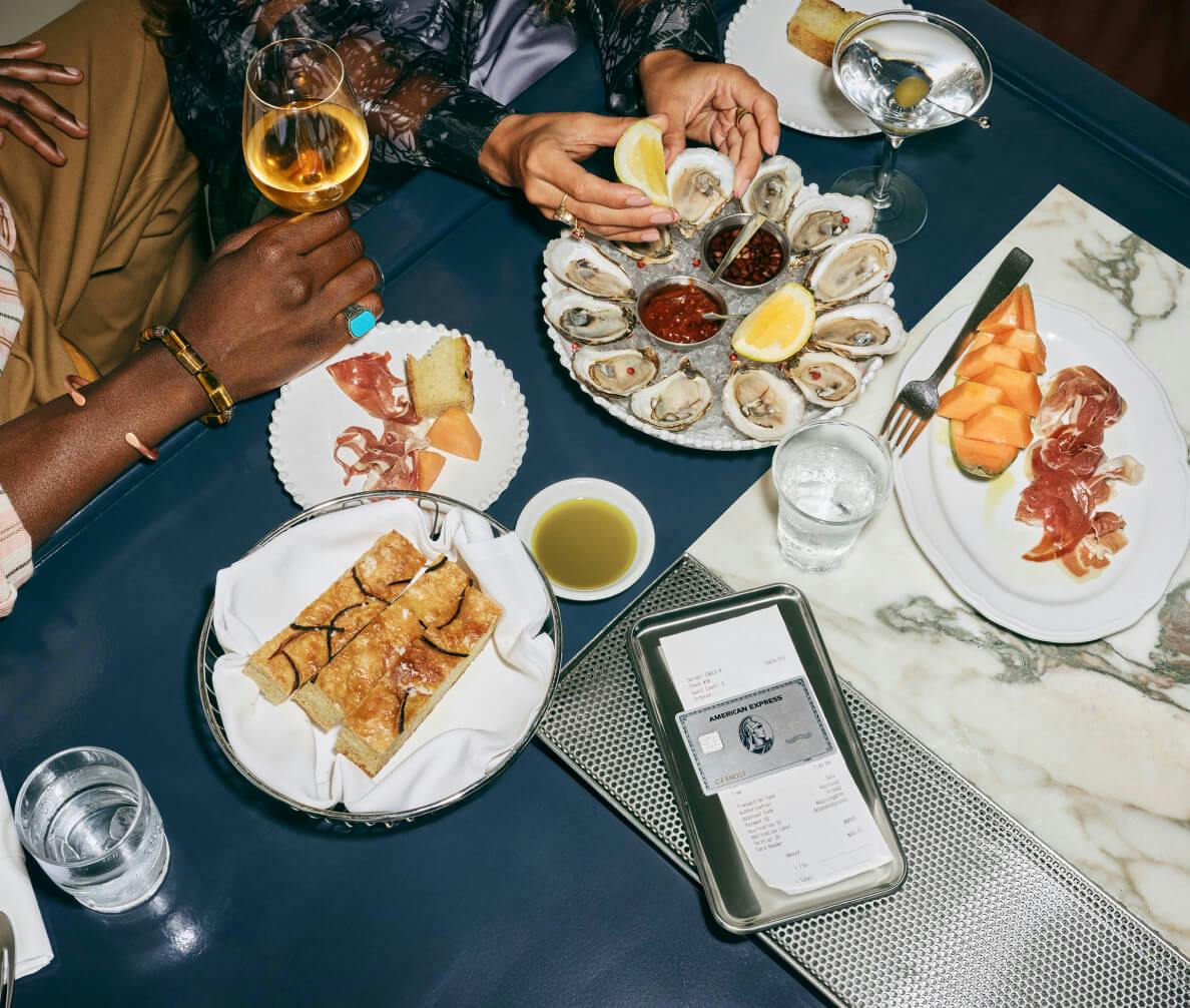 credit card on top of check with a restaurant scene in the background