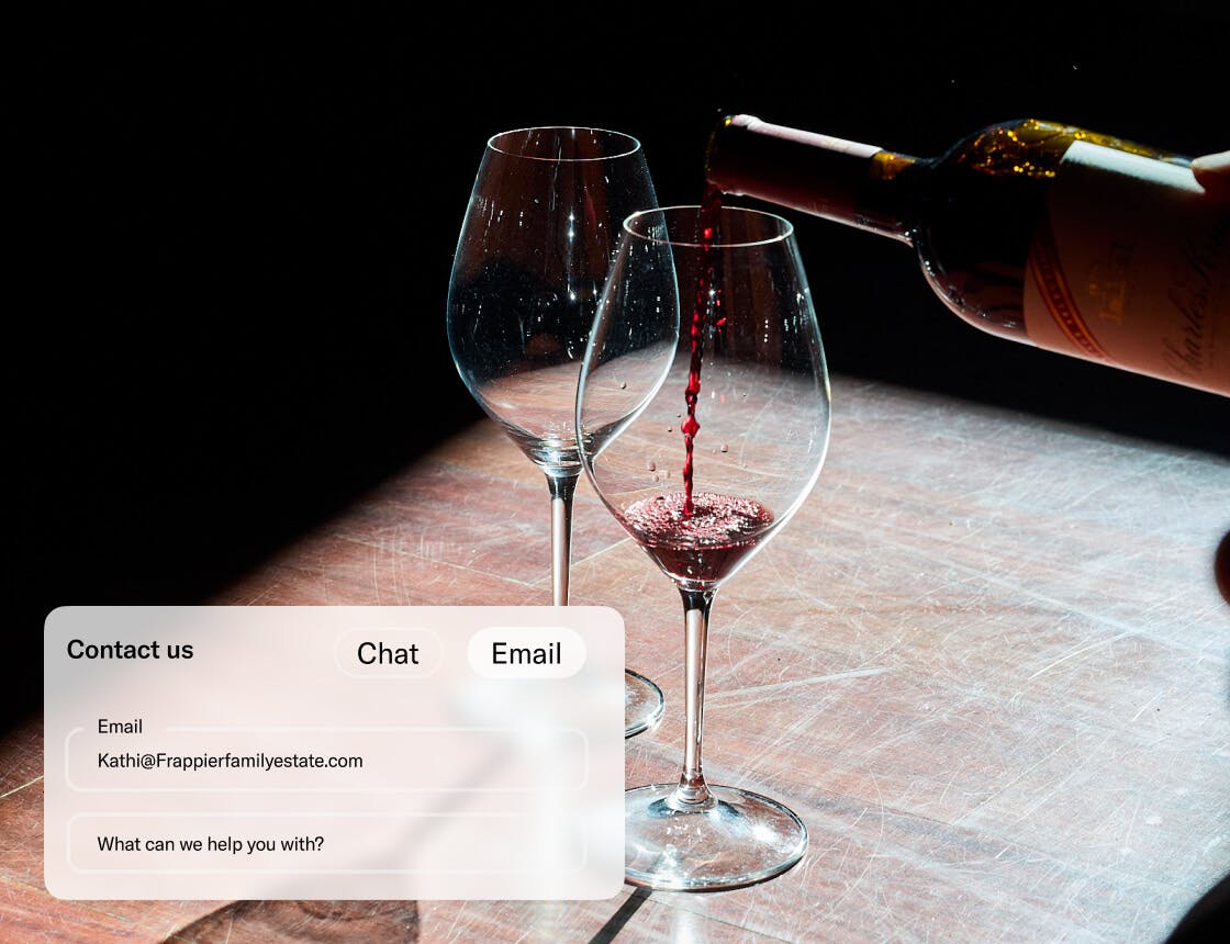Red wine being poured into a glass with a dark background and a contact UI overlay