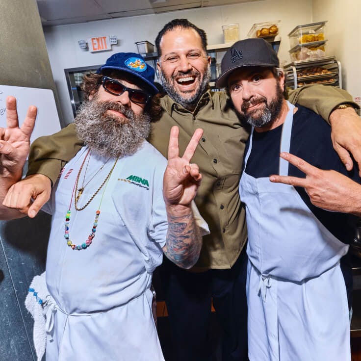Jon & Vinny's chefs and owners celebrating in front of the camera