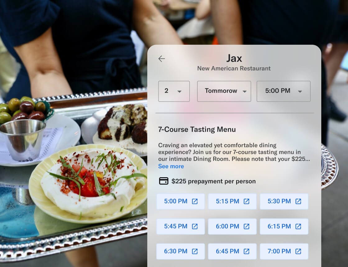 Server carrying olives, chees and bread on a sliver tray with a reservation times UI overlay