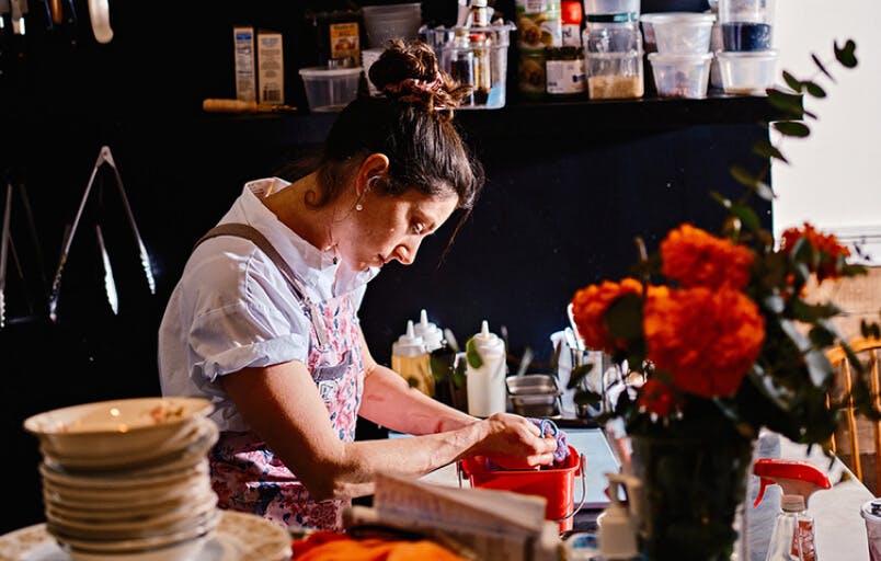 Chefs preparing food with natural light in an open kitchen